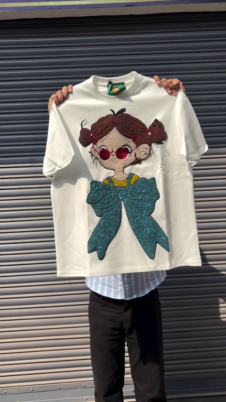 Black Oversized Graphic T-Shirt with 3D Textured Cartoon Girl Appliqué & Statement Teal Bow Design 🖤🎀✨