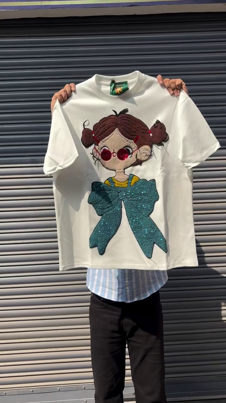 Black Oversized Graphic T-Shirt with 3D Textured Cartoon Girl Appliqué & Statement Teal Bow Design 🖤🎀✨