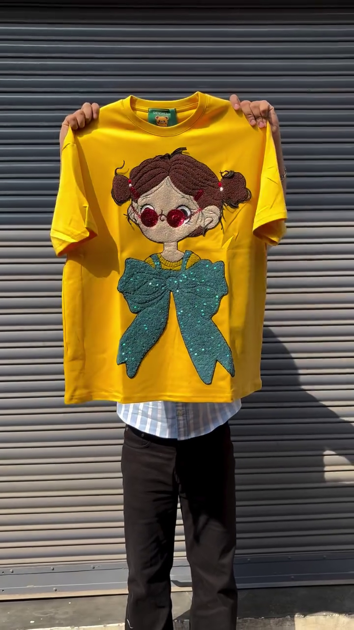 Black Oversized Graphic T-Shirt with 3D Textured Cartoon Girl Appliqué & Statement Teal Bow Design 🖤🎀✨